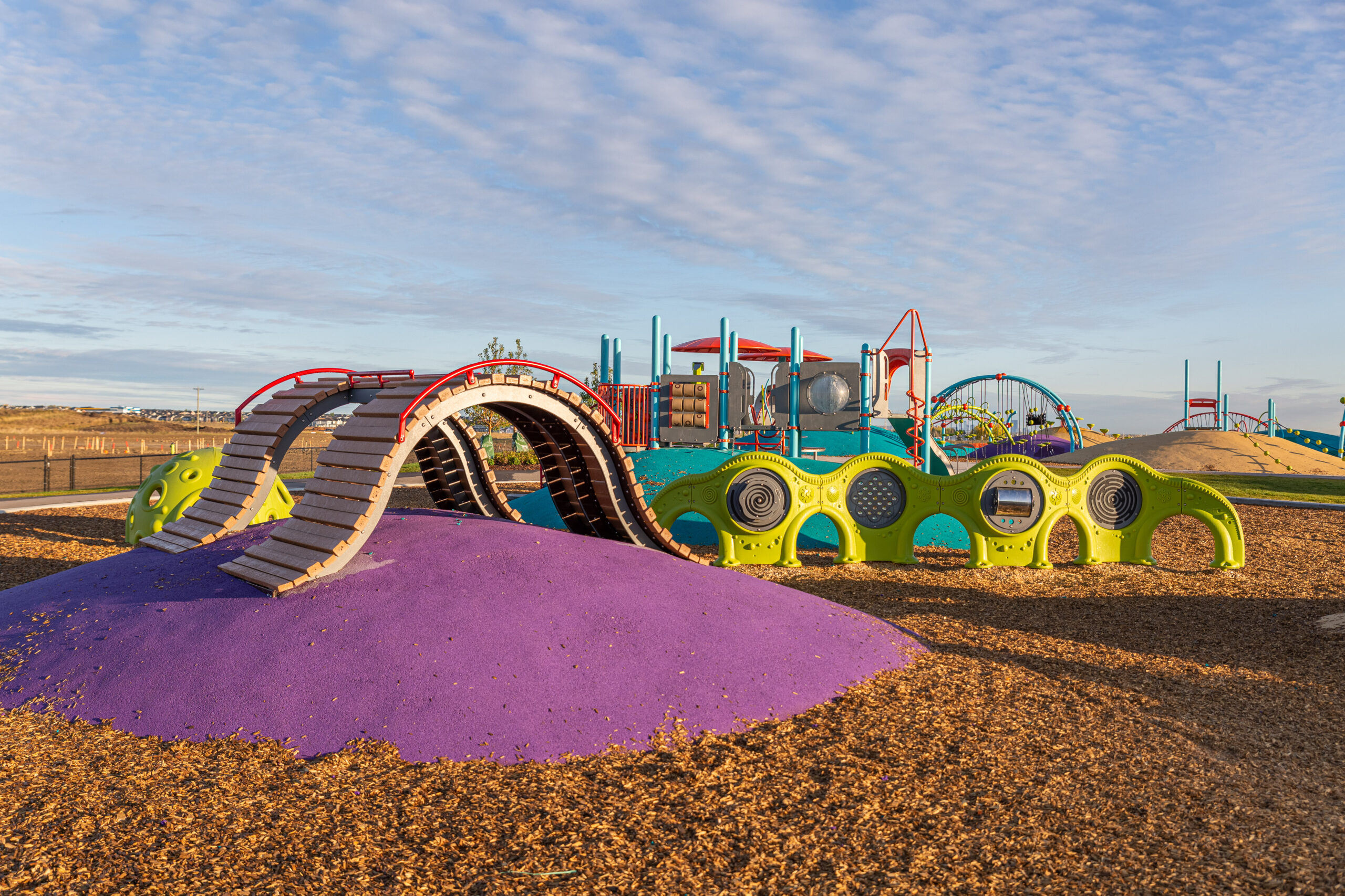 The award-winning Mounds of Fun Playground in Belmont with colourful play structures.